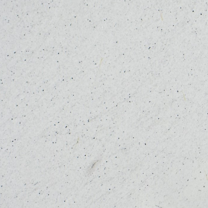 Granito Di Capri White de piedra natural en color blanco con delicadas inclusiones minerales oscuras, ideal para mesadas, islas de cocina, revestimientos y proyectos de arquitectura e interiorismo.