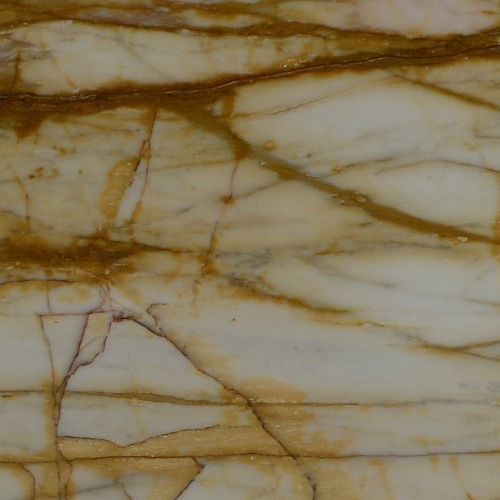 marmol-giallo-di-sienna Mármol Giallo Di Sienna natural con fondo claro y expresivas vetas doradas, ocres y marrones, ideal para mesadas de baño, revestimientos y proyectos de interiorismo.